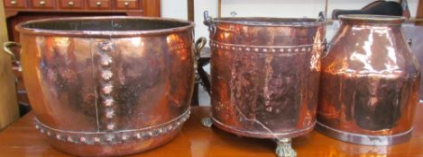 A large copper log basket with twin brass handles together with a coal bucket on brass lions paw