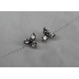 A pair of three stone diamond earrings, set with three round brilliant cut diamonds approximately 0.