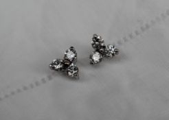 A pair of three stone diamond earrings, set with three round brilliant cut diamonds approximately 0.