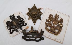 A Royal Artillery brass helmet plate together with a Victorian British Helmet plate,