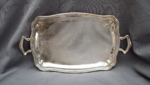 A Camusso Peruvian sterling silver twin handled tray, with a raised line rim,