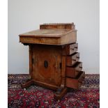 A Victorian walnut Davenport, the raised superstructure with a three quarter gallery,