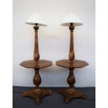 A pair of gilt decorated standard lamps / tables,