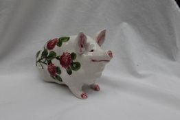 A Wemyss ware seated pig painted with flowers, painted marks Exon 1373 B Adams,