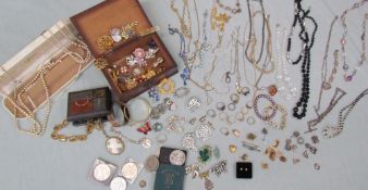 Assorted costume jewellery including brooches, cufflinks, coins, charms, earrings, rings, bracelets,