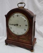 A Regency mahogany bracket clock, with a brass carrying handle above a domed top,