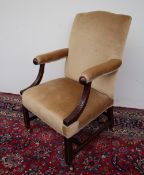 A George III mahogany framed armchair, the padded back and arms above swept reeded arm supports,