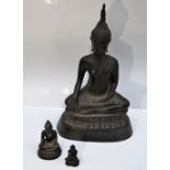A bronze of a seated Buddha, on a cast base, 22cm high together with two smaller seated Buddhas, 6.