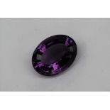 An unmounted amethyst, of oval faceted form, measuring approximately 21mm x 16mm, approximately 3.