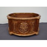 A large gilt decorated planter of rounded form with leaf pierced roundels on reeded circular feet,