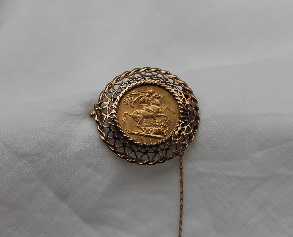 A George V gold sovereign dated 1913, in a yellow metal pierced frame mount, unmarked,