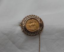 A George V gold sovereign dated 1913, in a yellow metal pierced frame mount, unmarked,