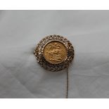 A George V gold sovereign dated 1913, in a yellow metal pierced frame mount, unmarked,