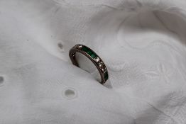 An emerald and diamond half eternity ring,