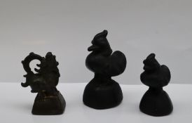 Three bronze opium weights, including a graduated pair in the form of ducks,