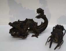 A Chinese bronze dragon, with gaping mouth and raised scrolling tail,