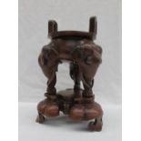 A Chinese bronze Koro, with twin arched handles, the legs in the form of elephant heads,