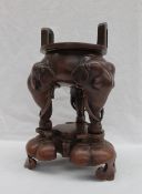 A Chinese bronze Koro, with twin arched handles, the legs in the form of elephant heads,