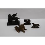 A small bronze model of a winged lion, with foot raised on a tablet, 62mm long,