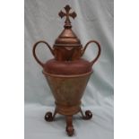 An ecclesiastical brass double spouted water jug, the domed cover with a cross atop,