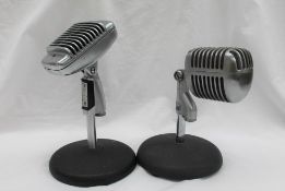 A Unidyne model 55S Dynamic microphone on a circular base togehter with a Shure Model 51 Sonodyne