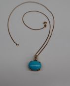 A turquoise and diamond pendant,