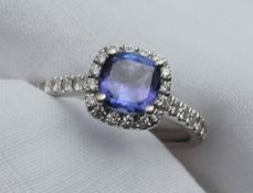 A tanzanite and diamond ring, the central square cut tanzanite approximately 1.