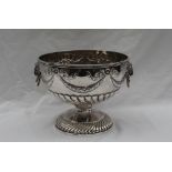 A Victorian silver punch bowl with a swirl gathering to foot and body with garlands to lion mask