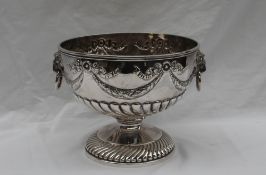 A Victorian silver punch bowl with a swirl gathering to foot and body with garlands to lion mask