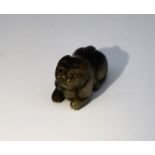 A Chinese carved jade pendant in the form of a recumbent cat,