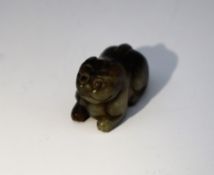 A Chinese carved jade pendant in the form of a recumbent cat,