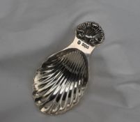 An Elizabeth II silver caddy spoon with a shell shaped bowl and fan shaped handle, Sheffield, 1968,