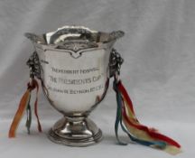 A George V silver trophy cup, with a pierced rim, tapering body,