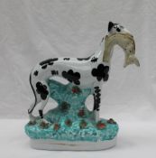 A Staffordshire figure of a dappled greyhound,