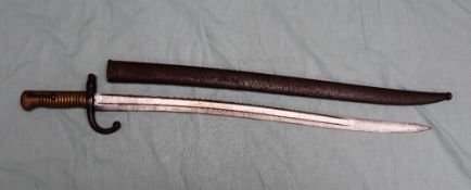 A French Chassepot bayonet with a ribbed brass handle and a fullered blade marked with a crown,