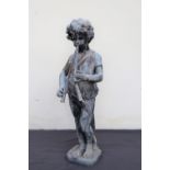 A lead figure of a small boy playing pipes on a square base,