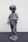 A lead figure of a small boy playing pipes on a square base,