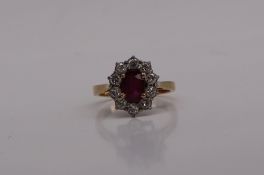 A ruby and diamond cluster ring, the central oval ruby,