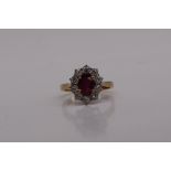 A ruby and diamond cluster ring, the central oval ruby,