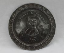 A white metal child's plate, the border embossed with the alphabet,