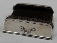 An Edwardian silver pen wipe, of square form with bristles to the side and base, two handles,