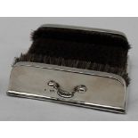 An Edwardian silver pen wipe, of square form with bristles to the side and base, two handles,