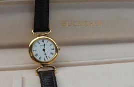 A Lady's Bucherer wristwatch, with a white dial and Roman numerals on a leather strap,