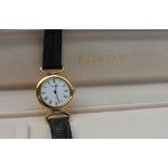 A Lady's Bucherer wristwatch, with a white dial and Roman numerals on a leather strap,