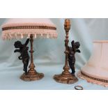 A pair of bronzed cherub table lamps,