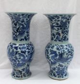 A pair of Chinese blue and white porcelain vases of baluster shape with a flared top,
