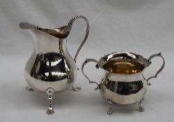 An Edwardian silver cream jug of plain baluster form, beaded S shaped handle,