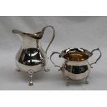 An Edwardian silver cream jug of plain baluster form, beaded S shaped handle,