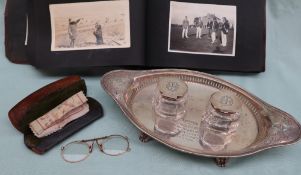 An Edward VII silver desk standish, of oval form, with vase pierced handles,