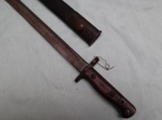 A 1907 pattern Wilkinson bayonet with a 43cm fullered blade in a leather scabbard